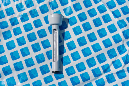 Floating thermometer for the pool on the blue floor pattern. Clear, detailed shot.の写真素材