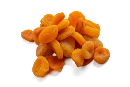 A top view of dried apricots in a loosely piled arrangement. The apricots are isolated on a white background.の写真素材