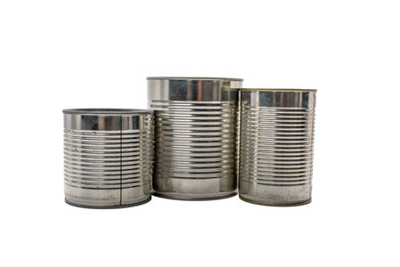 Three empty metallic tin cans standing upright, isolated on a white background. Varying in size, suitable for food packaging.の写真素材