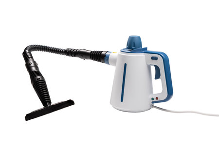 The steam cleaner is equipped with a long flexible hose and flat floor attachment. It is isolated on a white background and ready for extended surface cleaning.の写真素材