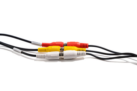AV RCA cable trio. Close-up of a white, yellow, and red AV RCA cable. The plugs are arranged side by...