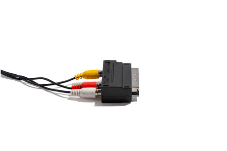 Oblique view of a SCART adapter with yellow, red, and white AV cables. The adapter lies on a white...