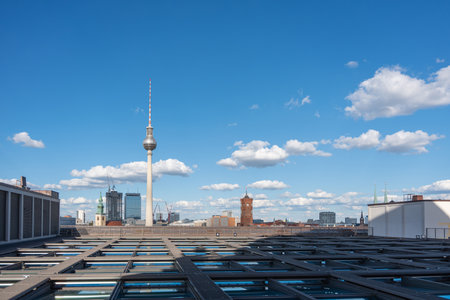 The Berlin TV Tower rises above rooftops with the Rotes Rathaus nearby. Clear skies and scattered clouds complete the panorama.の写真素材