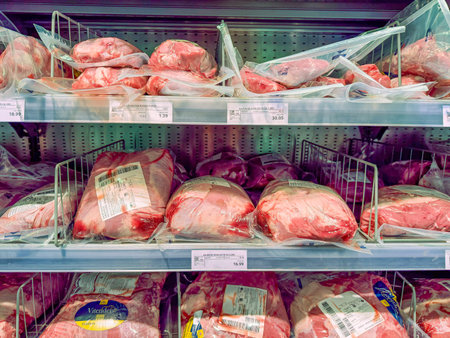 Germany Berlin February 7, 2026. Wide view of packaged beef cuts stored in supermarket freezer shelves. Industrial food storage concept with chilled meat products for retail sale.のeditorial素材