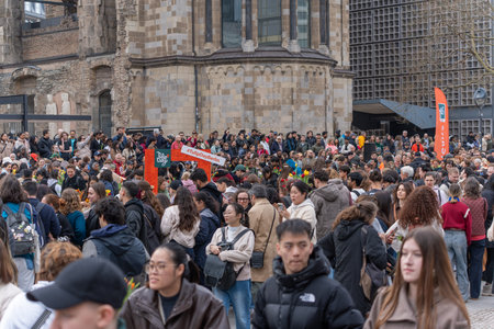 Germany Berlin March 14, 2026. Participants in a large Berlin crowd hold fresh tulips during a...