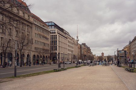 Germany Berlin March 27, 2026. Overcast sky looms above quiet urban street. Historic buildings line...