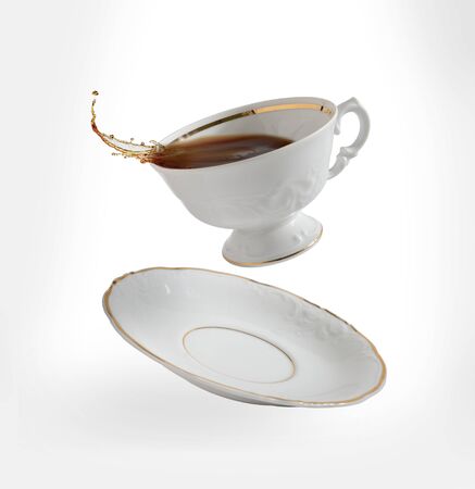 cup of tea flying and splashing, on white backgroundの写真素材