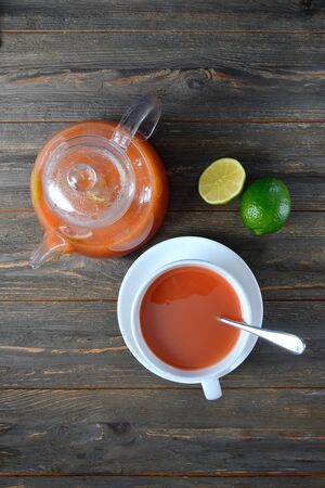 hot sea buckthorn drink served in a glass teapot. top view.の写真素材