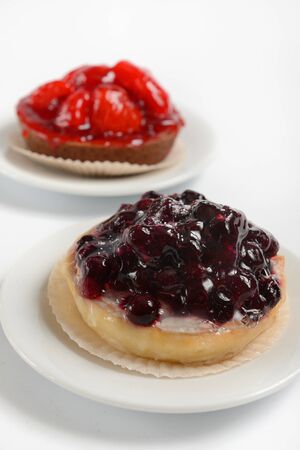 baskets of dough with berries (strawberries and currants) on a white background.の写真素材