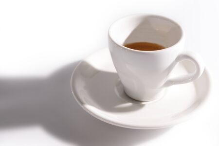 cup of coffee with a shadow on a white background.の写真素材