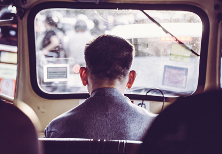 Tuk Tuk taxi driver from behind at Bangkok Thailand.の写真素材