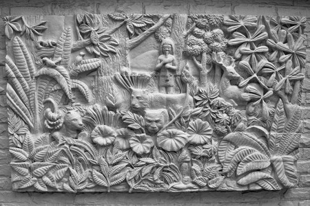 Wall artwork in a stone wall in Bangkok Thailand.の写真素材
