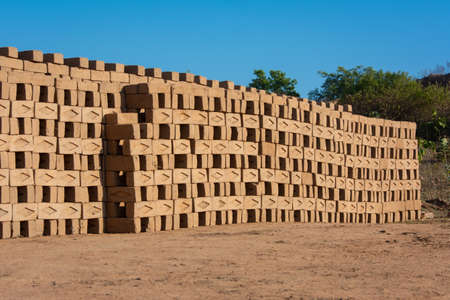 Hand made bricks from wet clay and mud are kept for drying before the burning process. Traditional production of clay bricks in India.の写真素材