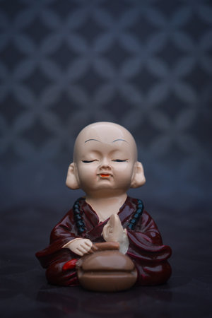 Cute little asian buddha statue. Buddhist monkの写真素材