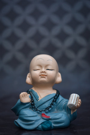 Cute little asian buddha statue. Buddhist monkの写真素材