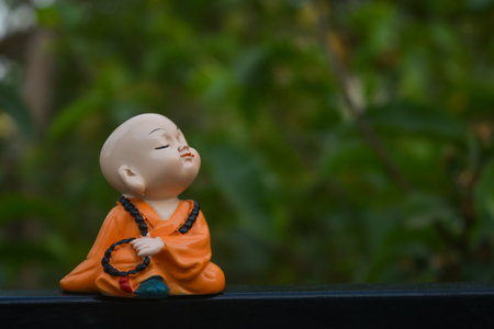 Cute little asian buddha statue. Buddhist monkの写真素材
