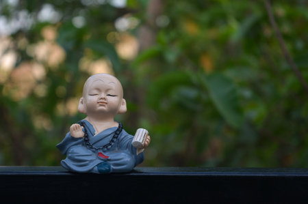 Cute little asian buddha statue. Buddhist monkの写真素材