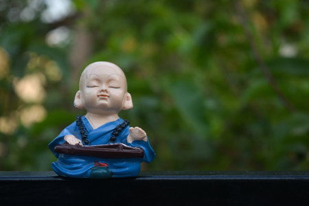 Cute little asian buddha statue. Buddhist monkの写真素材