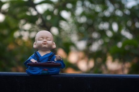 Cute little asian buddha statue. Buddhist monkの写真素材