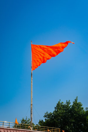 Hindu flag fluttering against a clear blue sky
