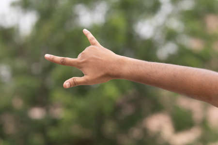 male hand gesture and signs on outdoor backgroundの写真素材