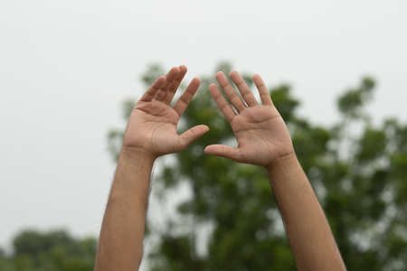 male hand gesture and signs on outdoor backgroundの写真素材