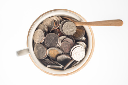 The currency on Wood in white backgroundの写真素材