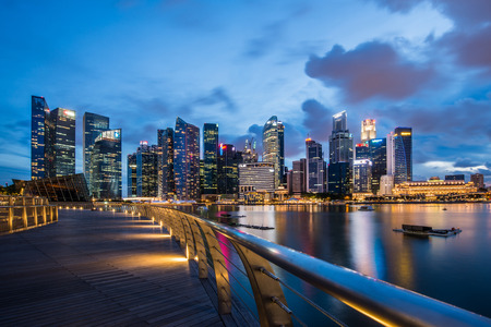 Marina Bay central business district in Singapore. Late evening panorama of popular tourist area in downtown of city. Merlion statue in the front is the symbol of Singaporeのeditorial素材