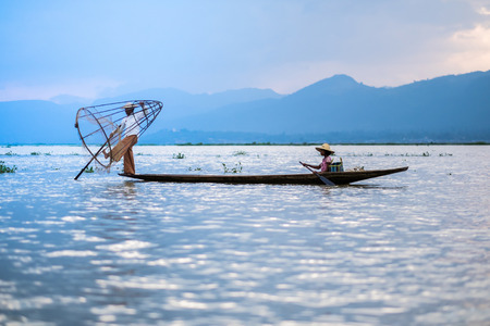 Mandalay - October 15: Fishermen catch fish Oct 15, 2014 in Mandalay. Fishermen show ancient way of fishing netsのeditorial素材