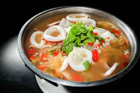 Thai Food,Squid ring in spicy soup in black backgroundの写真素材