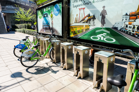 Bangkok, Thailand - January 15, 2015: White and green rental Bangkok Smile Bikes at a docking station on Sathorn Roadのeditorial素材