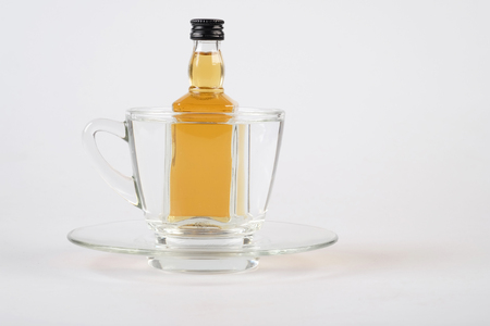 whiskey in cup on white tableの写真素材