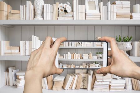 Girl taking pictures on mobile smart phone in Vintage Libraryの写真素材