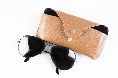 Sunglasses in brown leather case. blackground on white.の写真素材