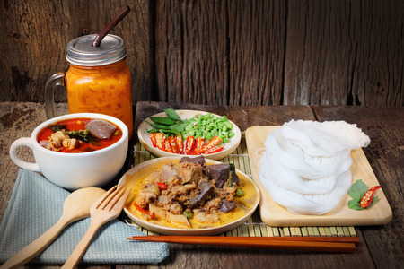 (Kanom jeen) Noodles and Chicken curry with vegetable on wood background Food collection in Thialandの写真素材