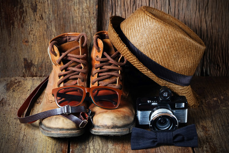 Shoe hat and accessories travel set on a wooden backgroundの写真素材