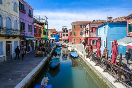 VENICE, ITALY, on March 29, 2015. Burano island, multi-colored houses of locals. Cafe on the bank of the channel. Burano the islandのeditorial素材