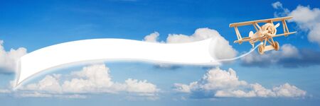 Wooden plane flying on the sky and spcae for you textの写真素材