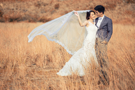 Happy romantic young couple in Meadowの写真素材