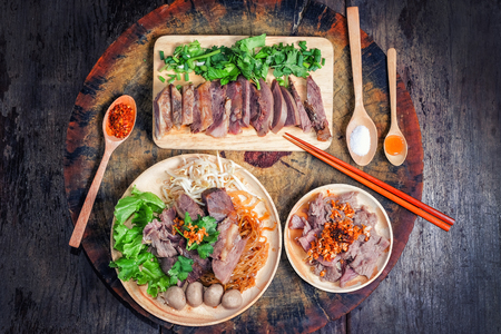 Thai food Noodle soup with beef on wood backgroundの写真素材