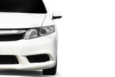 Close up front of white car in street on white backgroundの写真素材