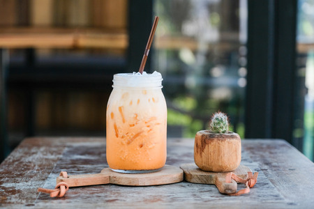 Iced thai tea with milk smoothies on wood tableの写真素材