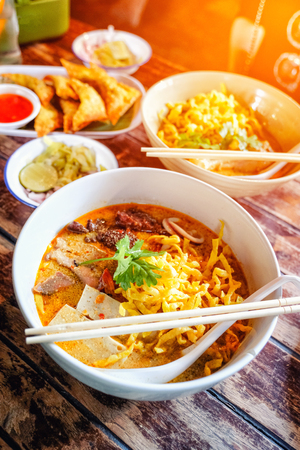 Northern Thai  Curried noodle soup (Khao soi) with chicken meat and spicy coconut milkの写真素材