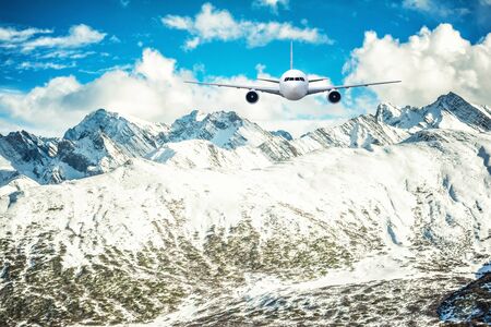 Airplane frying over the Snow Mountain backgroundの写真素材
