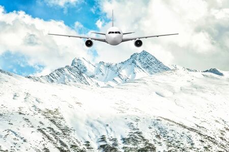 Airplane frying over the Snow Mountain backgroundの写真素材