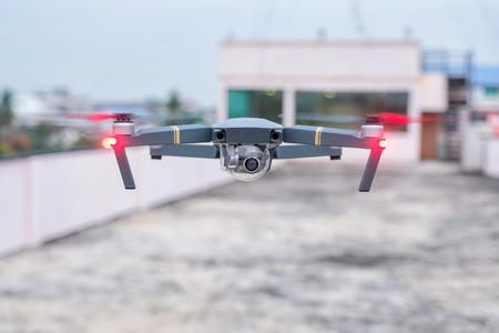 Black drone hovering in a sky