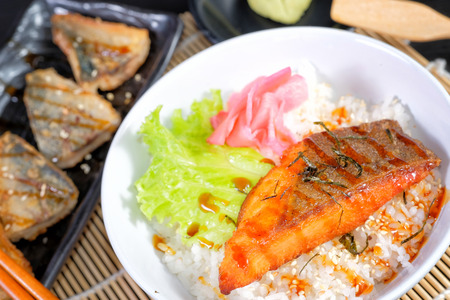 Grilled salmon steak with rice and vegetablesの写真素材
