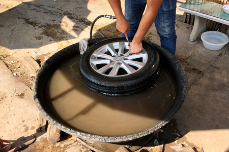 Finding a inner tube puncture in the water.の写真素材