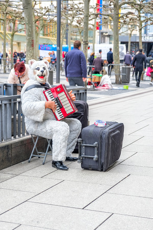 FRANKFRUT, GERMANY- MARCH 26, 2017: Human in Bears suit playing music at Street market on 26 march 2017 in Frankfrut Germanyのeditorial素材