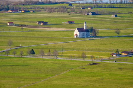 Countryside, Mountains, Green Grass Field and Church in Switzerlandの写真素材
